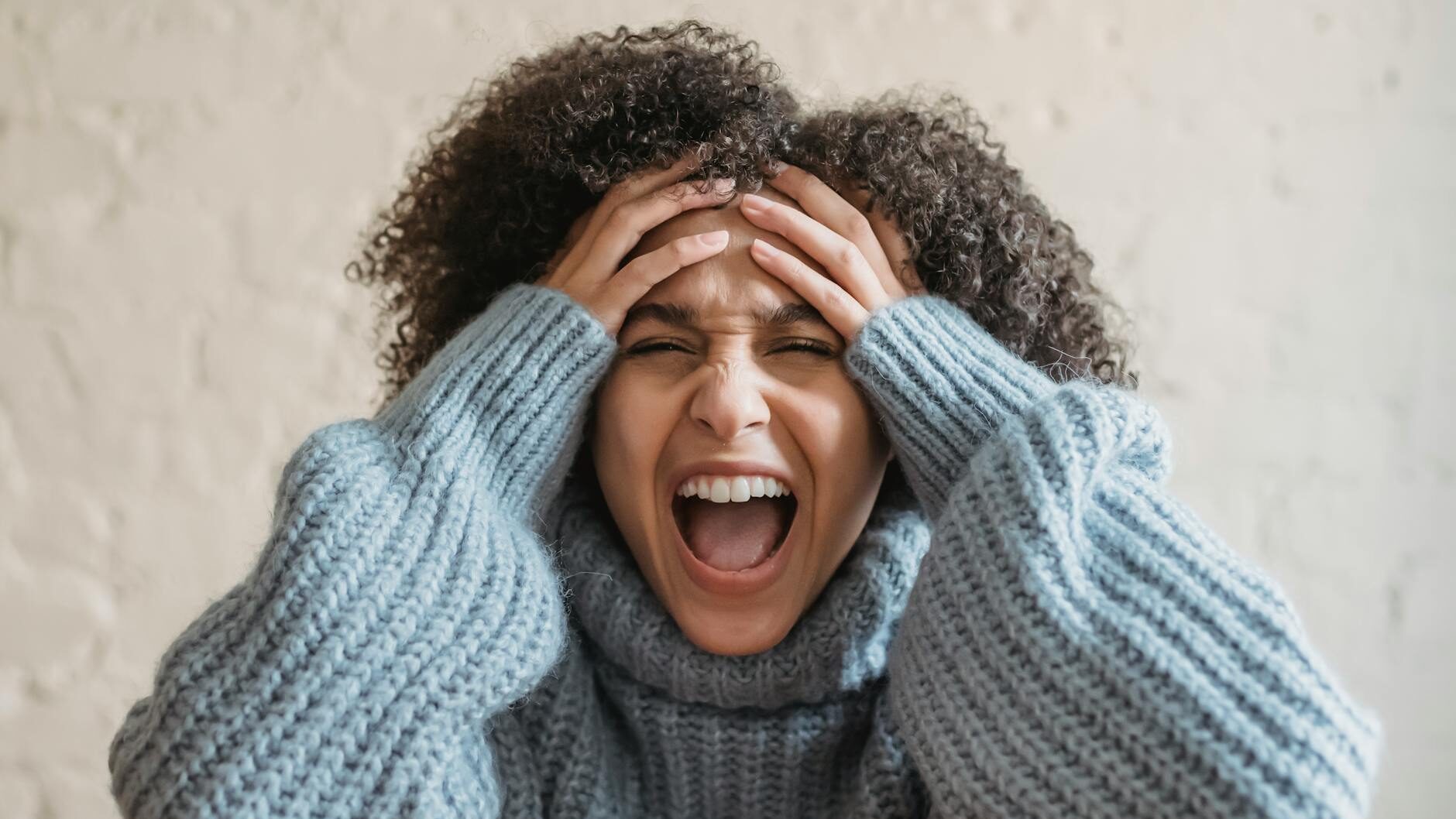 upset ethnic woman screaming in room