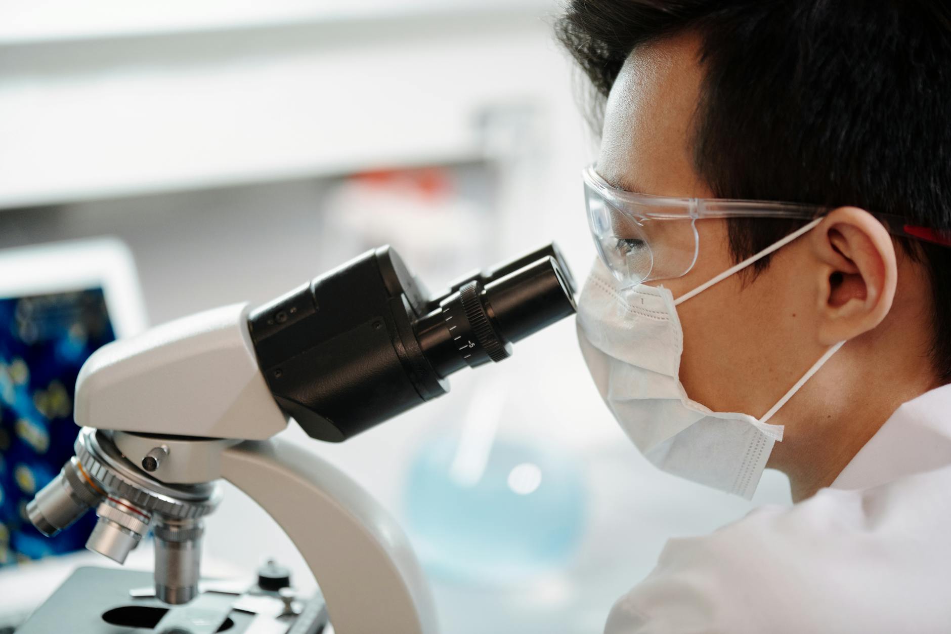 man looking through a microscope